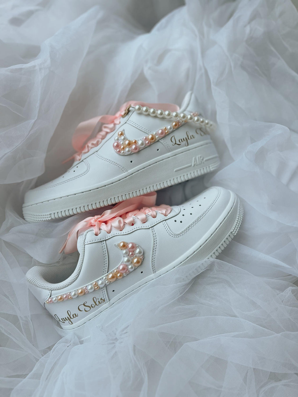 Top view of white wedding sneakers decorated with elegant pearl embellishments