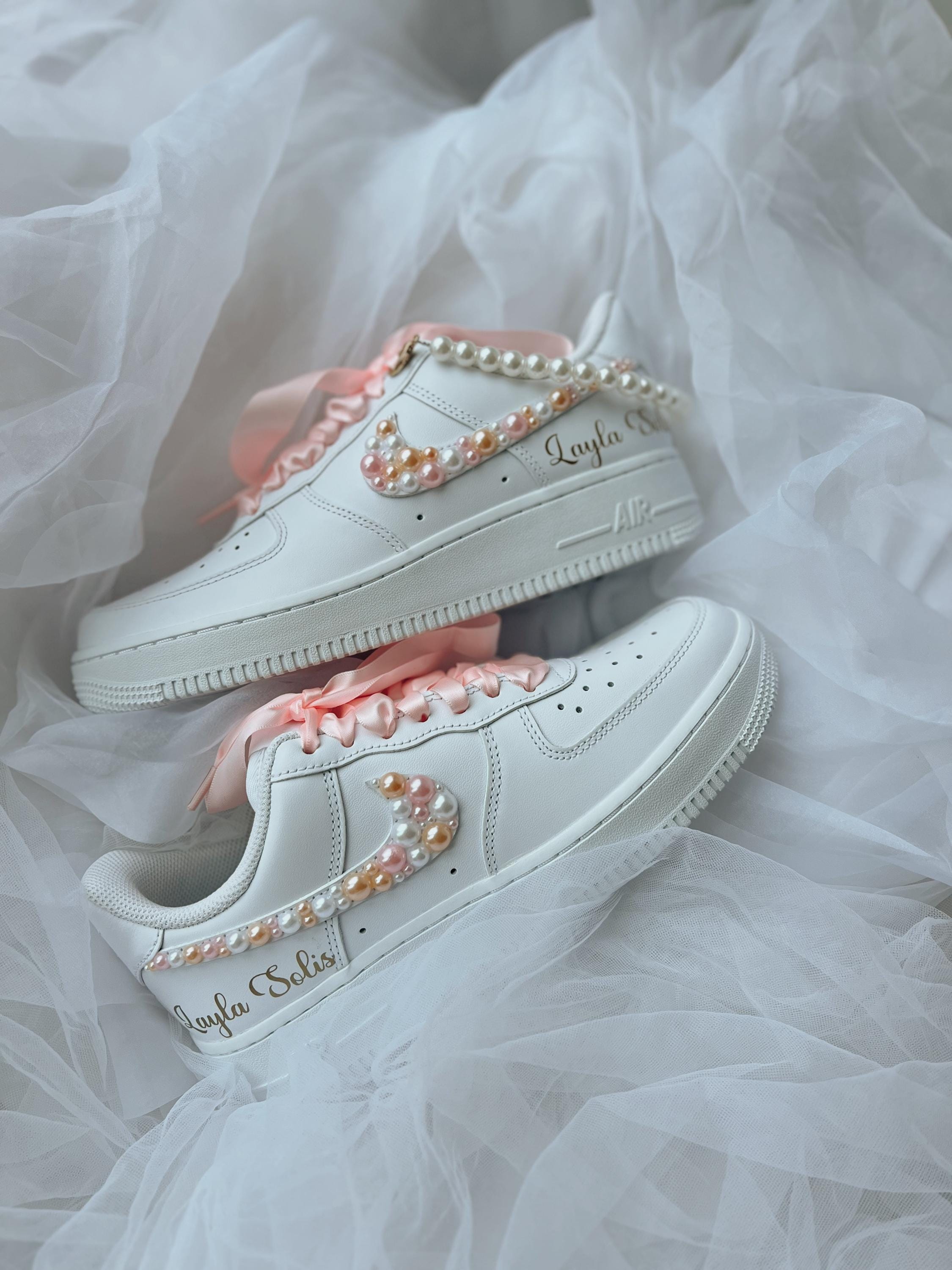 Top view of white wedding sneakers decorated with elegant pearl embellishments