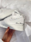 Bride wearing pearl wedding sneakers styled with a bridal gown