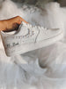 Elegant white Air Force 1 wedding sneakers with hand-applied pearls on the swoosh, flat bridal shoes for all-day wear