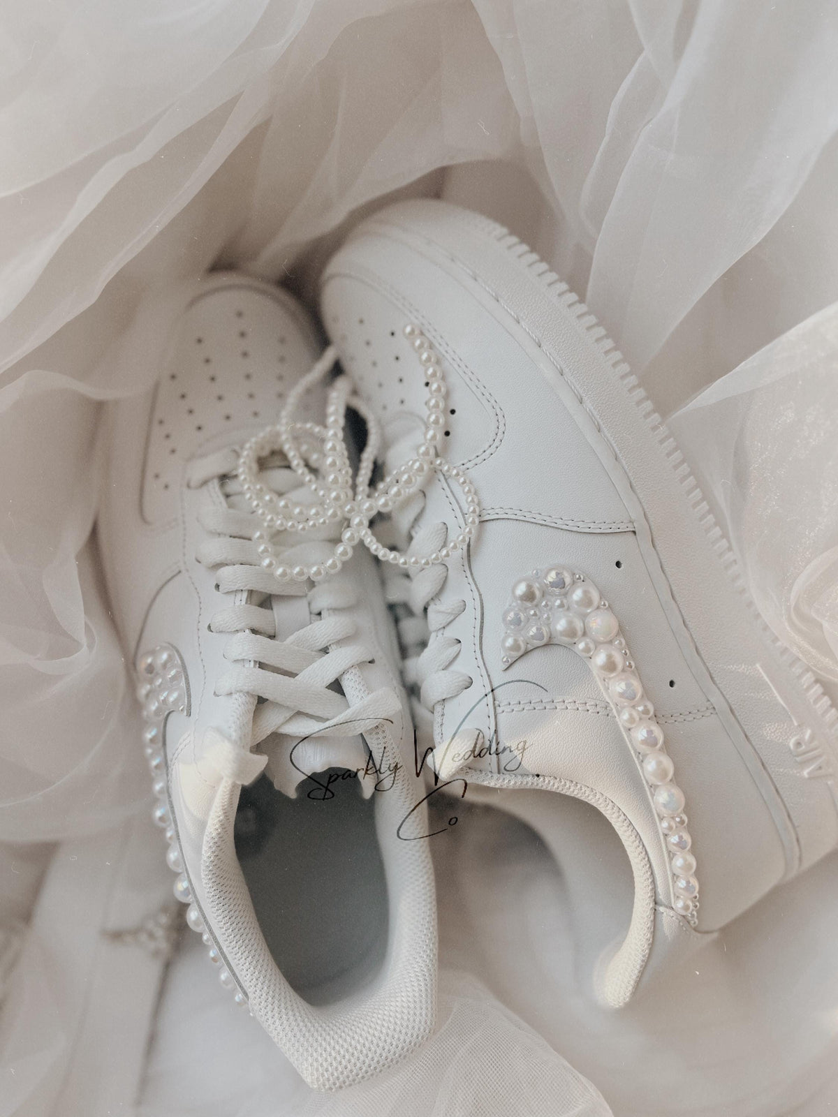 Side view of white Air Force 1 wedding sneakers with pearl embellishments on the outer swoosh, bridal sneakers for weddings