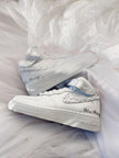 Close-up of hand-applied pearls on white wedding sneakers
