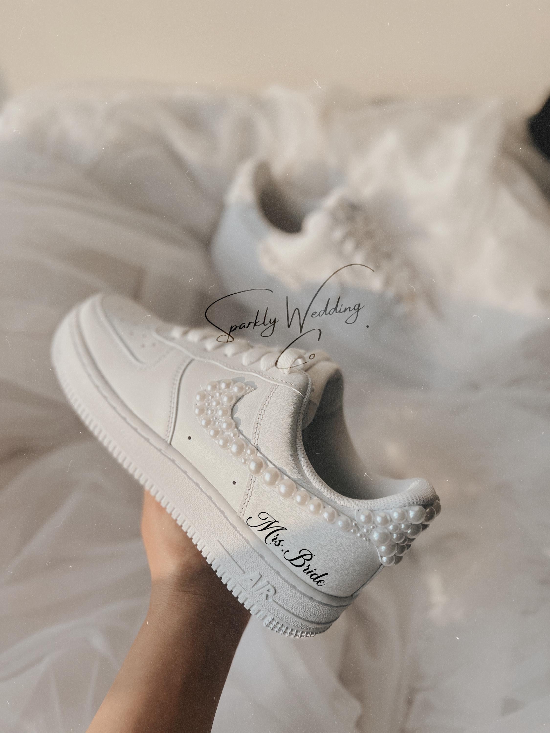 Close-up of custom pearl wedding sneakers showing pearls on the swoosh for bride
