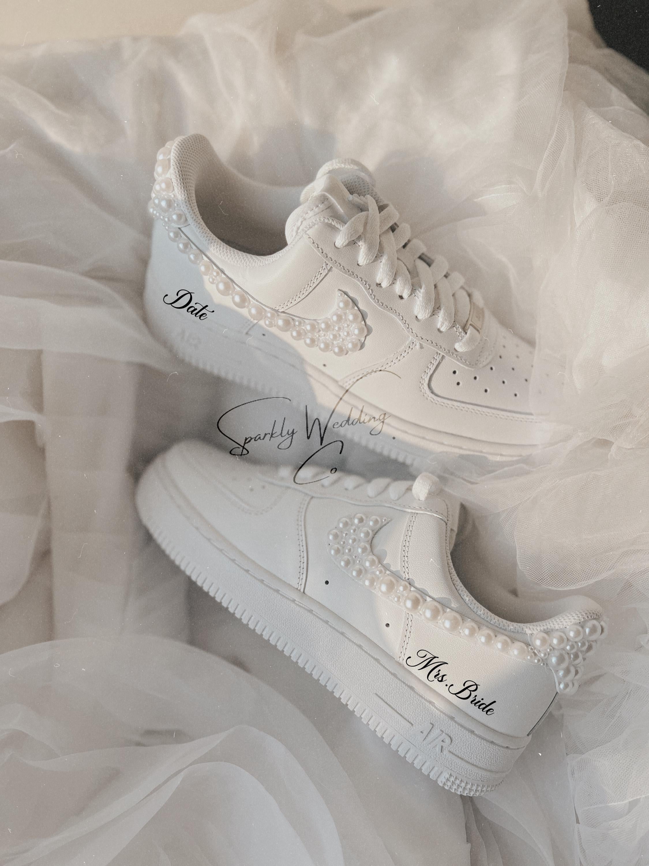 Angled view of white pearl wedding sneakers highlighting pearl embellishments on the swoosh

