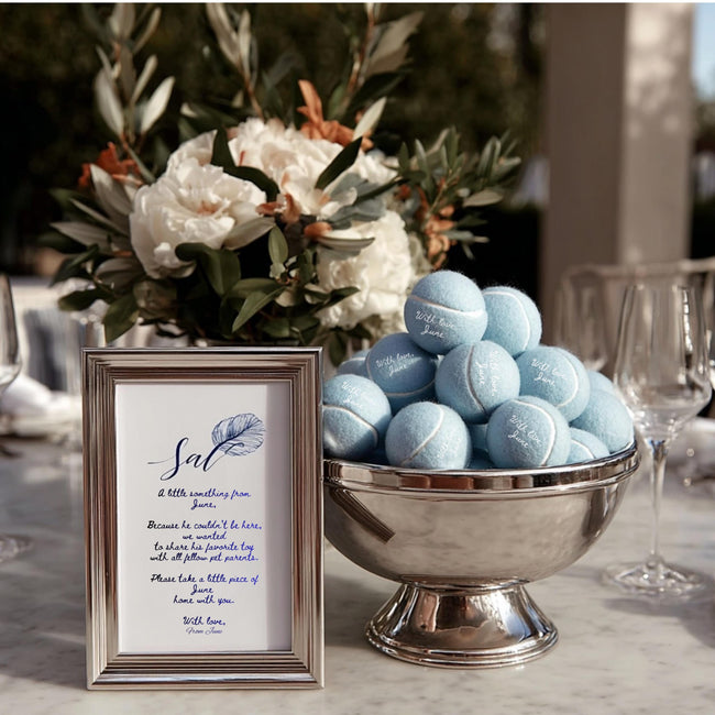 Close-up of custom text printed on tennis balls for wedding favors