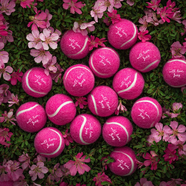 Personalized tennis balls designed as unique wedding favors for guests