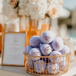 Set of personalized tennis balls prepared as wedding favors for guests