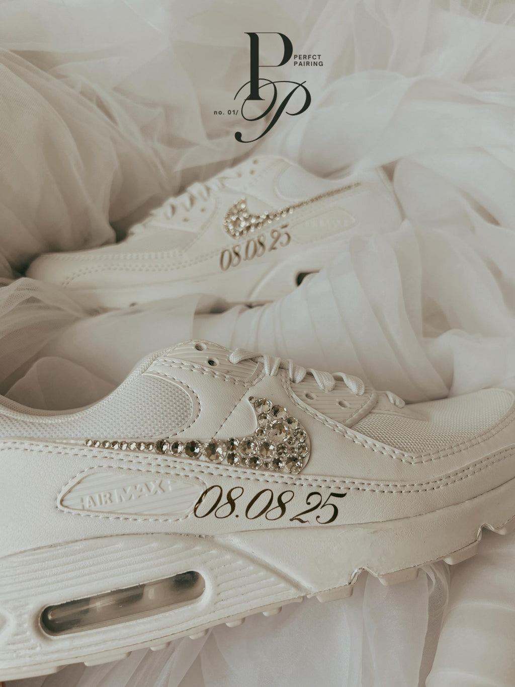 Side view of white Nike Air Max 90 bridal sneakers decorated with sparkling rhinestones for a wedding day look.