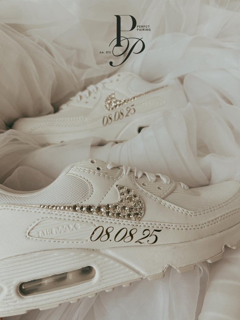 Side view of white Nike Air Max 90 bridal sneakers decorated with sparkling rhinestones for a wedding day look.
