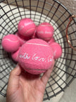 Close-up of printed personalization on tennis ball wedding favors