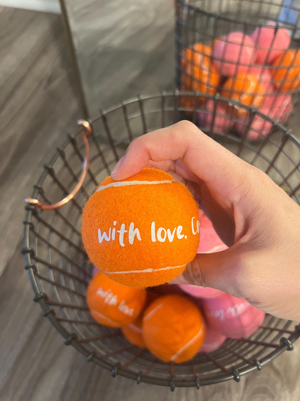 Close-up texture of tennis ball wedding favors with custom text