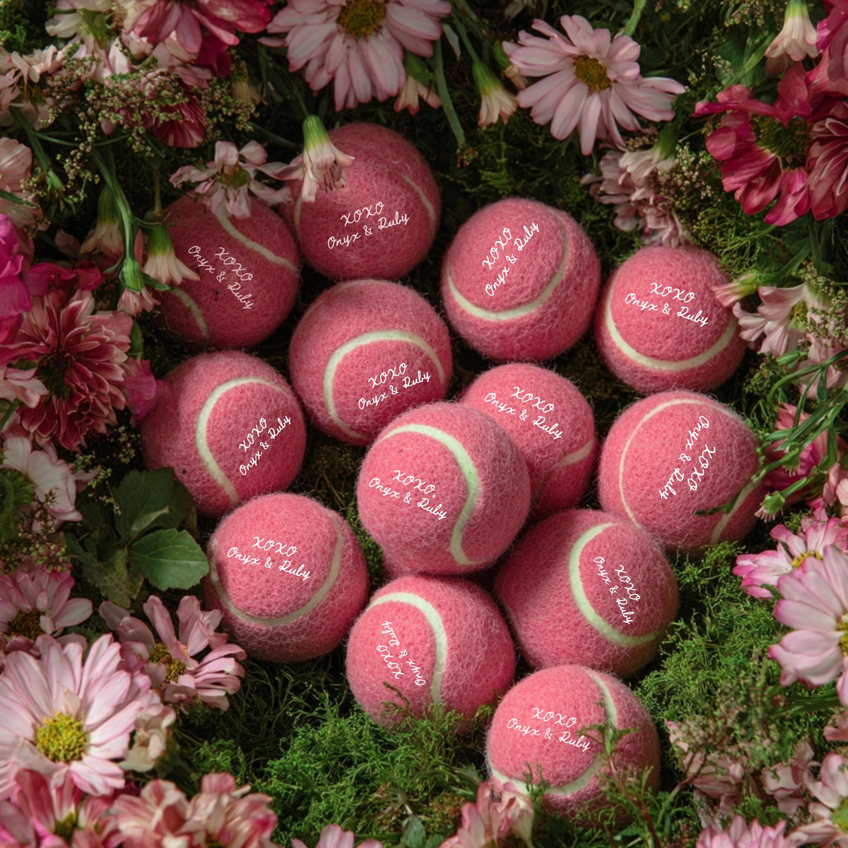 Custom tennis balls displayed on a wedding favor table setup