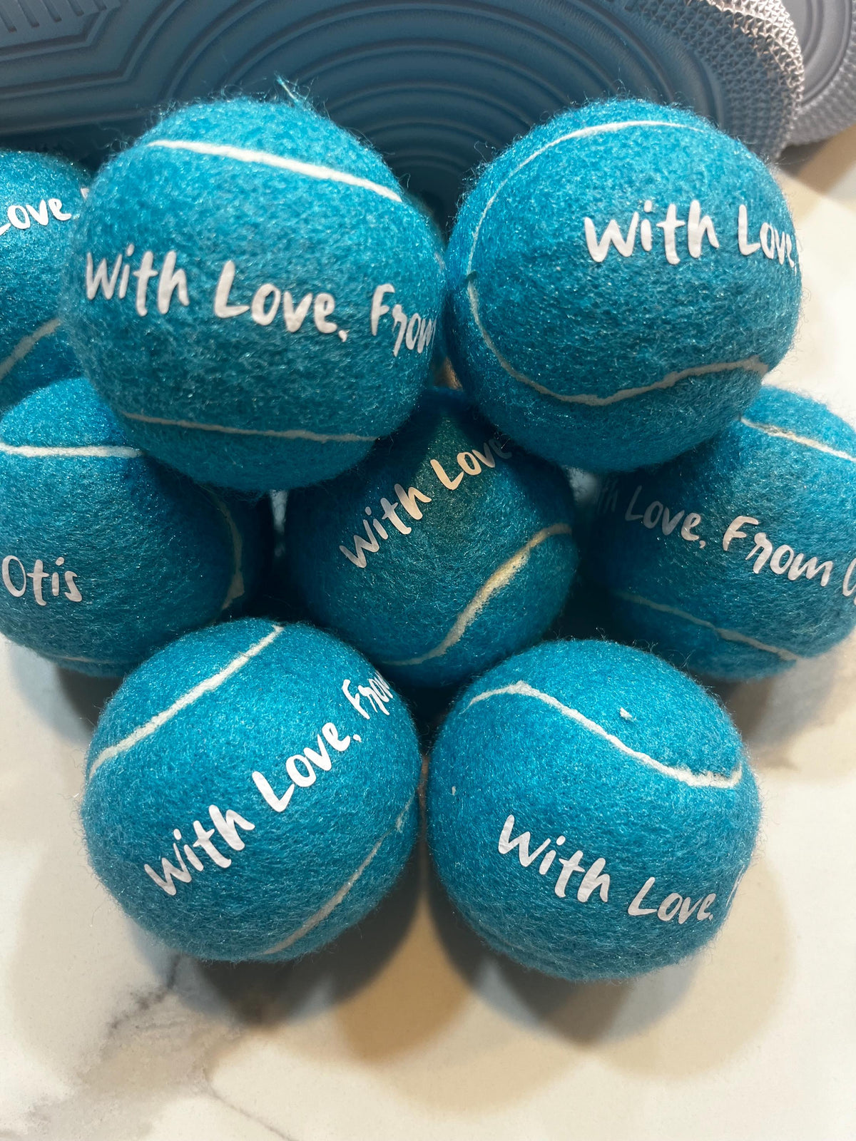 Custom tennis ball placed at guest table setting as wedding favor
