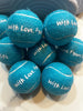 Custom tennis ball placed at guest table setting as wedding favor