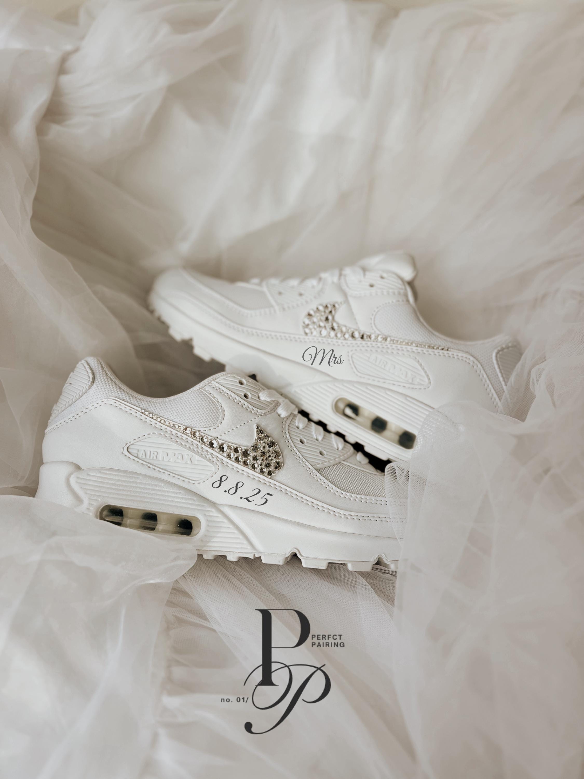 Elegant white Air Max 90 wedding sneakers styled in a bridal flat lay with soft neutral wedding tones.