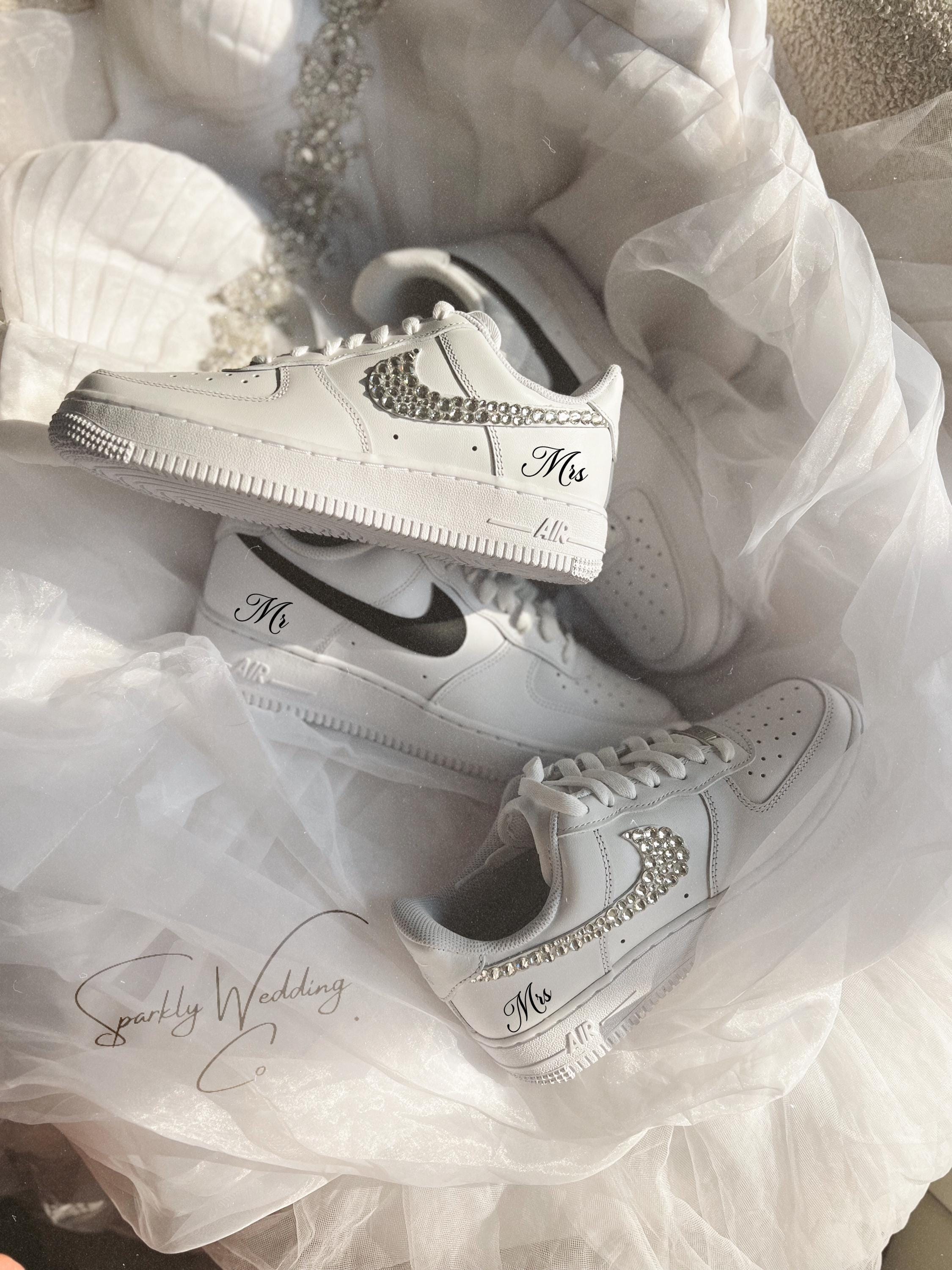 White sneakers with 'Mr' and 'Mrs' text on a white fabric background