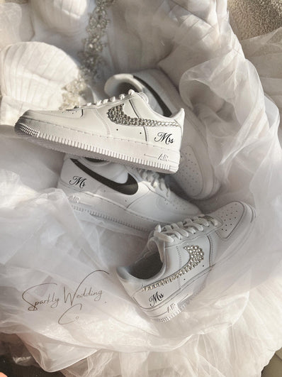 White sneakers with 'Mr' and 'Mrs' text on a white fabric background
