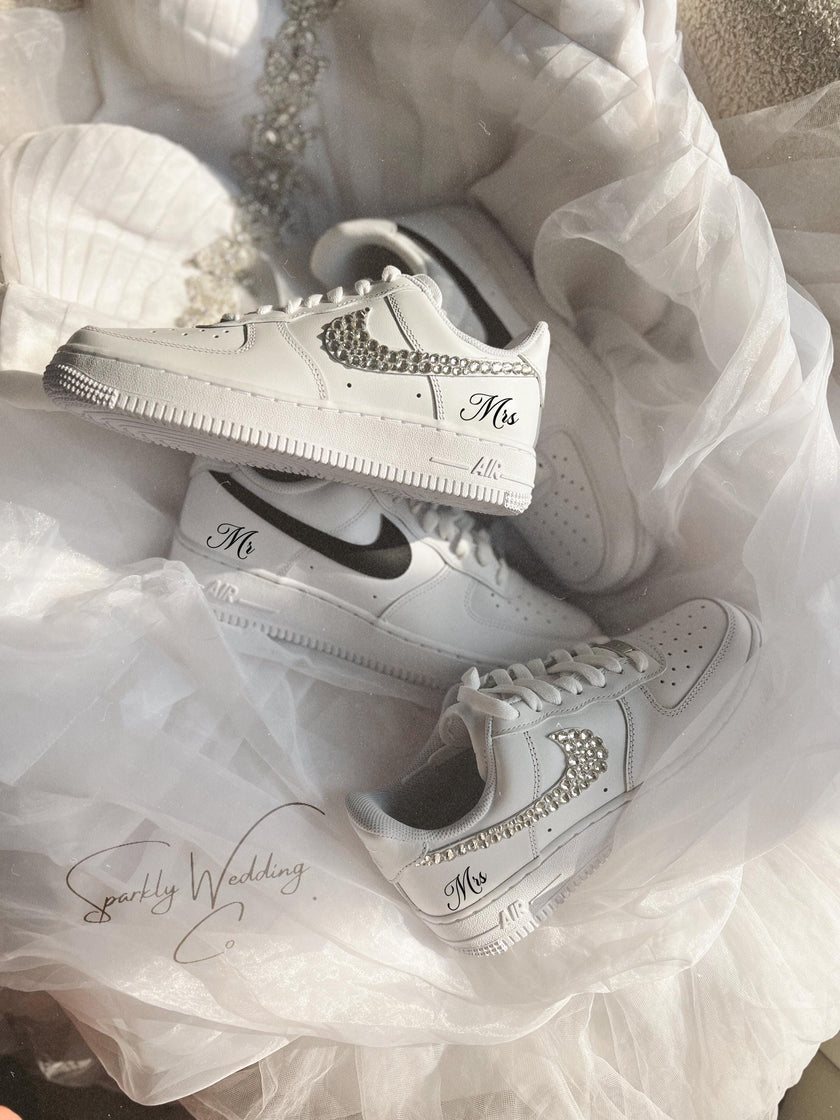 White sneakers with 'Mr' and 'Mrs' text on a white fabric background