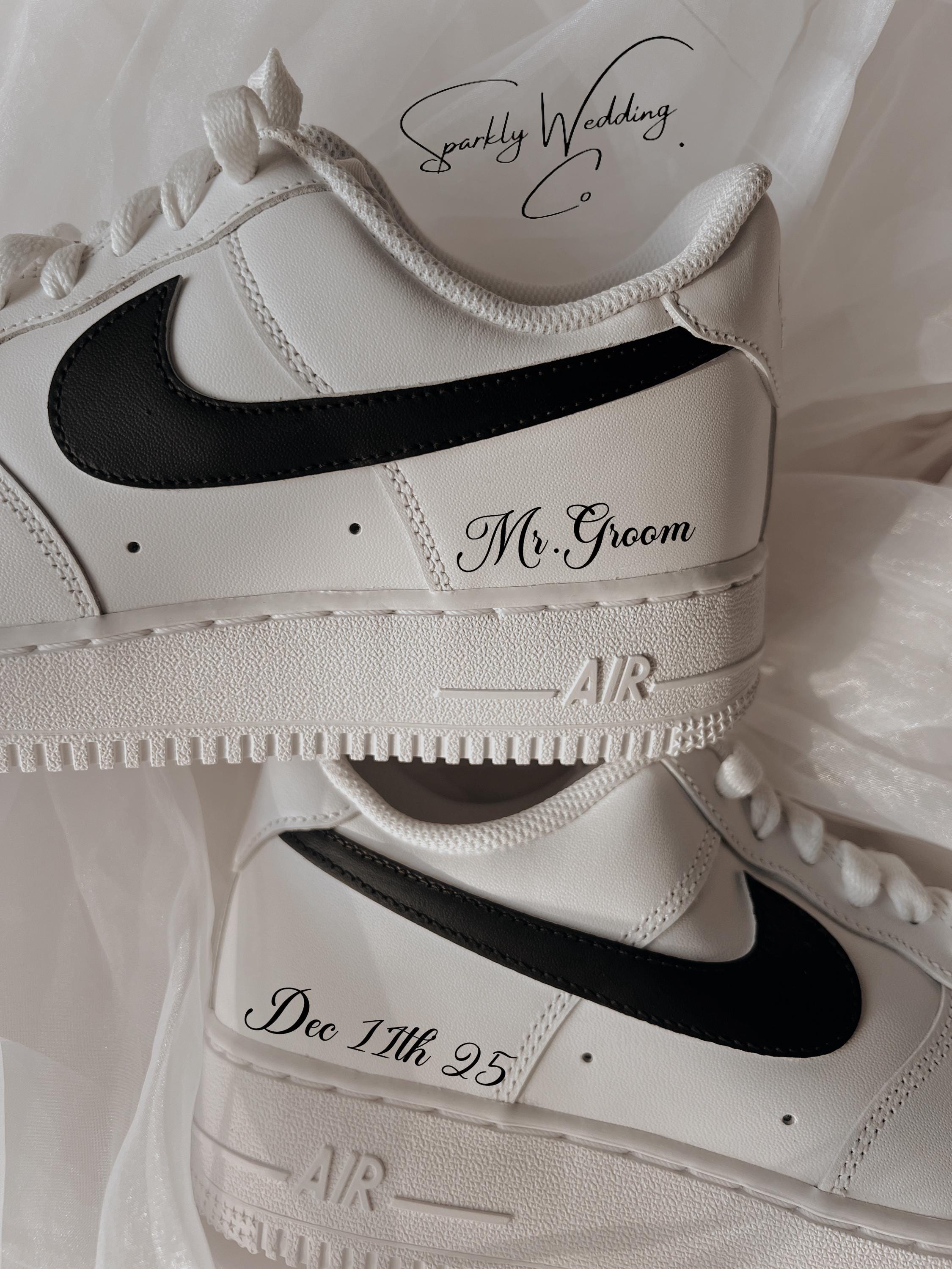 Custom black and white Nike Air Force 1 groom wedding sneakers with hand-painted outer swooshes, personalized with wedding name and date