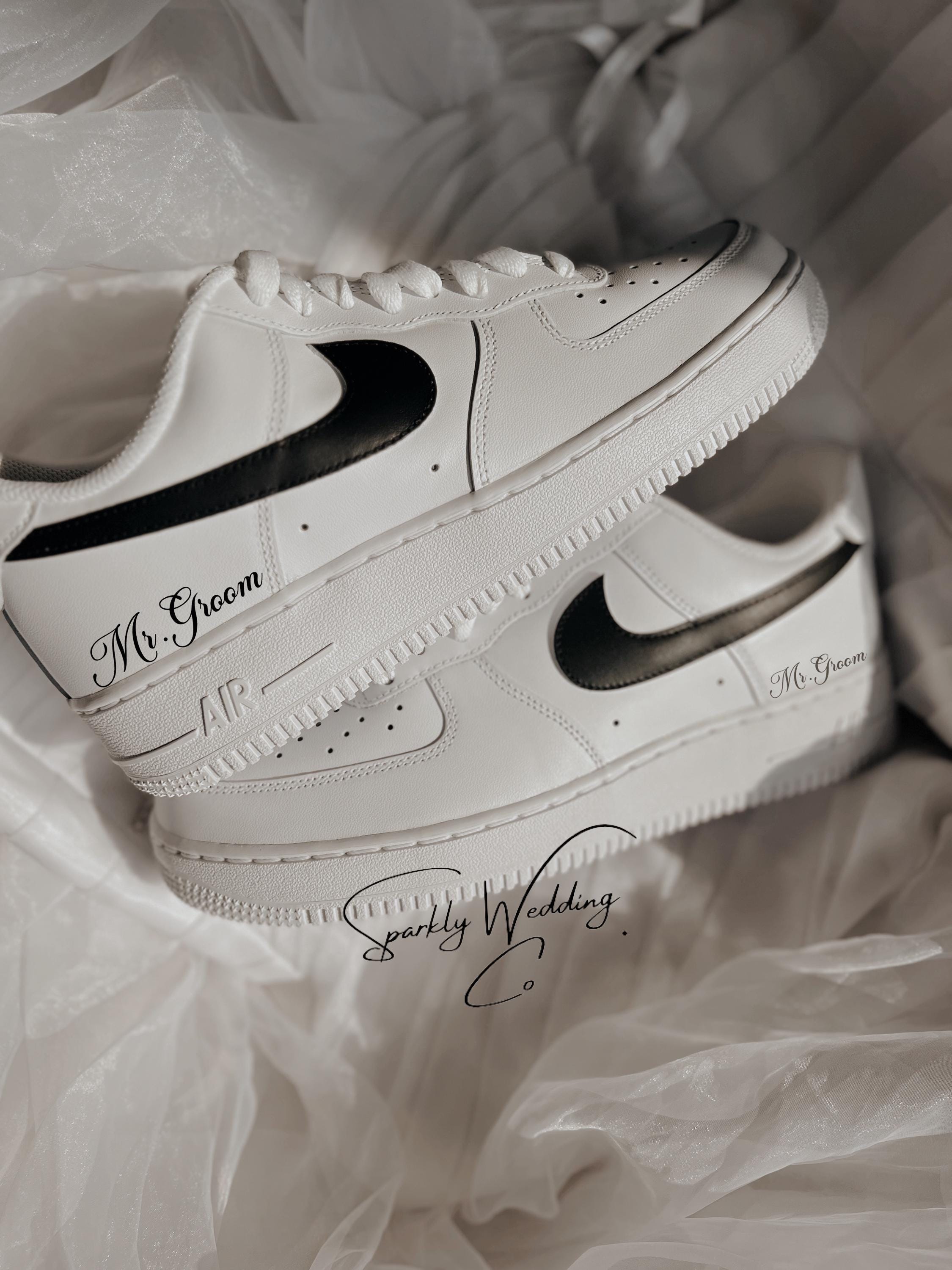 Custom black and white Nike Air Force 1 groom wedding sneakers with hand-painted outer swooshes, personalized with wedding name and date