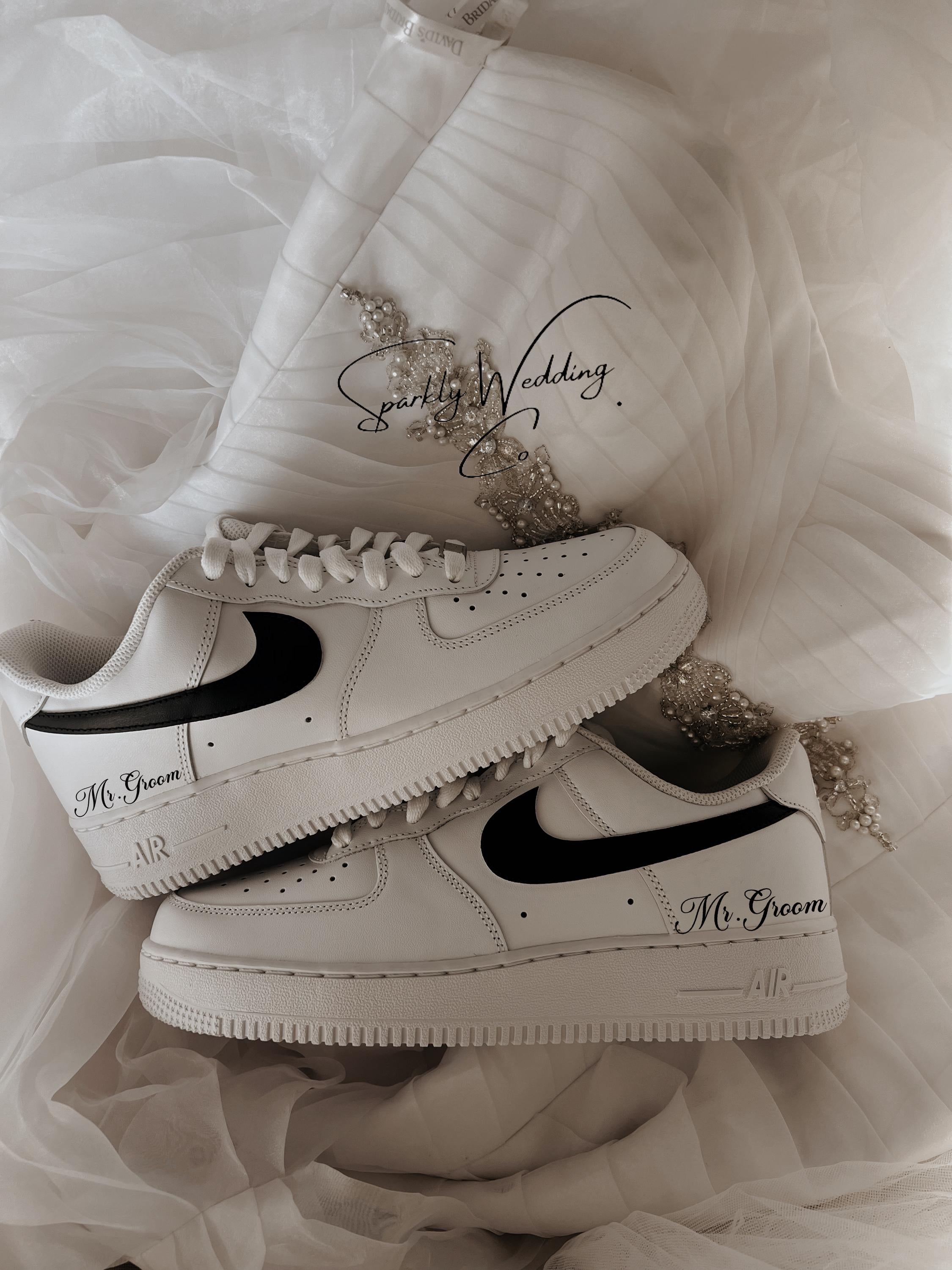 Custom black and white Nike Air Force 1 groom wedding sneakers with hand-painted outer swooshes, personalized with wedding name and date